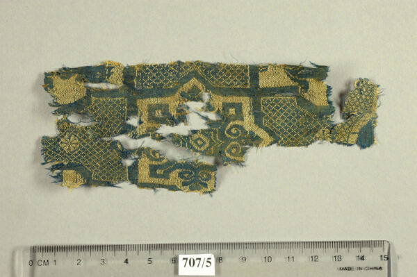 Cave 38, Silk, weft-faced compound tabby, octagon with stylized plant and geometric motifs. Photo by Clara Amit and Tzila Sagiv, courtesy of the Israel Antiquities authority