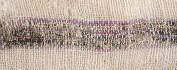 A cotton textile decorated with red cotton bands alternating with shiny silk, S-spun threads wound with silver strips, 'En Marzev. Photo by Clara Amit and Tzila Sagiv, courtesy of the Israel Antiquities authority