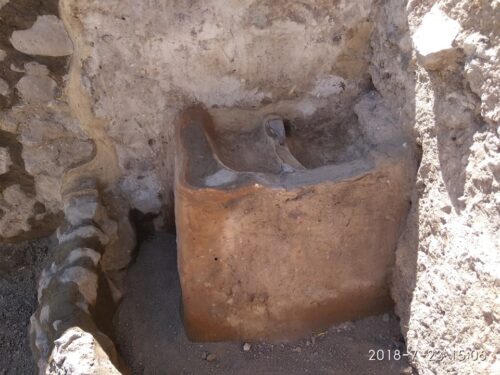 Plastered installation after conservation, featuring two plastered basins and enclosed by a low wall of fieldstones. Photography by Nisan Ben-Natan.