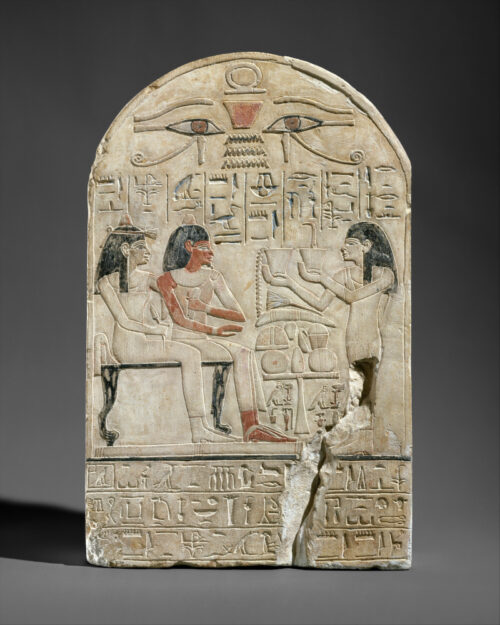 Stela depicting the lector priest Siamun and his mother, the singer Amenhotep, receiving offerings from Siamun’s wife, the chantress Iretnofret. The hetep hieroglyph appears in the center of the offering table between the figures. Metropolitan Museum of Art 1970.49.