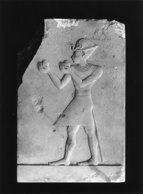 Artist’s practice carving of a king holding up goods in the traditional pose of offering in front of a deity, Walters Art Museum 22266. Public Domain via Wikimedia.
