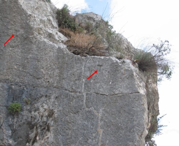 Northern face of the southern bedrock near the Tomb of Absalom. Note the two engraved Tau crosses and the three disc-/nail-like, carvings that appear on the lower right of the cross. Similar discs/nails are engraved in several places in this locus. Copyright Joe Zias.
