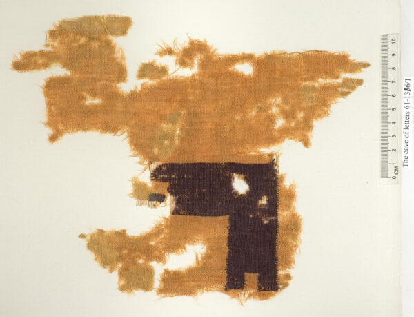 Textile fragment with gamma shape colored in purple hue. Wool, Cave of Letters, Roman period (Photo by Clara Amit, Courtesy of the Israel Antiquities Authority)