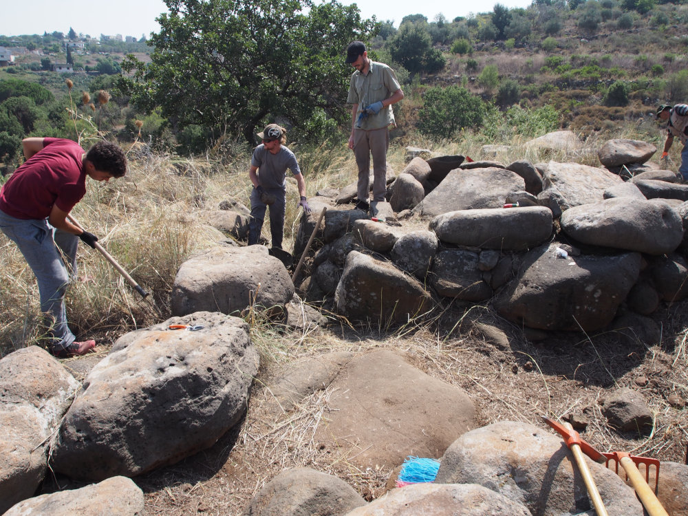 Cleaning and surveying a dolmen. Image courtesy of Tara Steimer-Herbet.