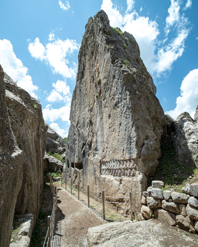 Chamber B of the rock sanctuary Yazılıkaya with its 12-meter-tall western wall displaying the reliefs of 12 gods of the underworld (© Luwian Studies).