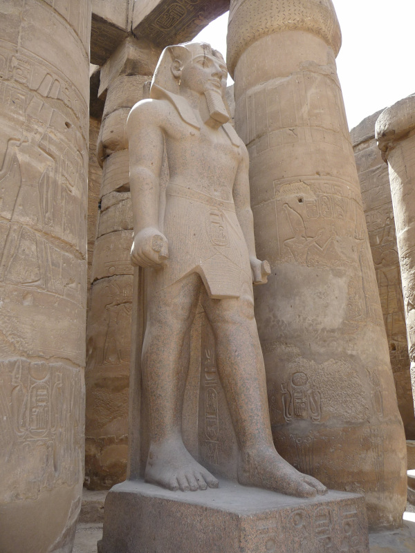 Statue of Pharoh Ramesses II, Luxor Temple. Photo by Merlin UK, CC by SA 3.0, via Wikimedia Commons.