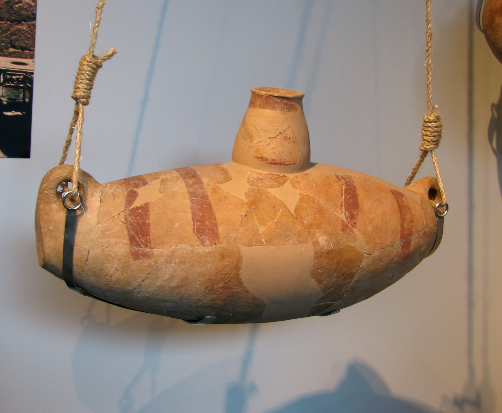 An extremely large ceramic vessel usually called a ‘churn,’ dating to the Chalcolithic period in the Southern Levant (ca. 4500 BCE), reputedly for making yogurt, although, this seems unlikely, since the aperture of the spout is too small for scooping out thickened material and pouring it would have made a mess. Fermented milk is the more likely substance. Either way, fermentation was involved. Photo by Hanay, CC BY-SA 3.0, via Wikimedia.