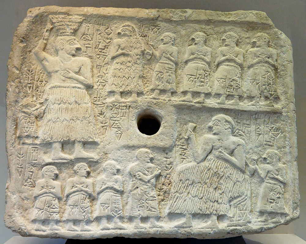 Ur-Nanshe relief with his wife facing him in the top register. Image by Marie-Lan Nguyen, CC BY 2.5, via Wikimedia.