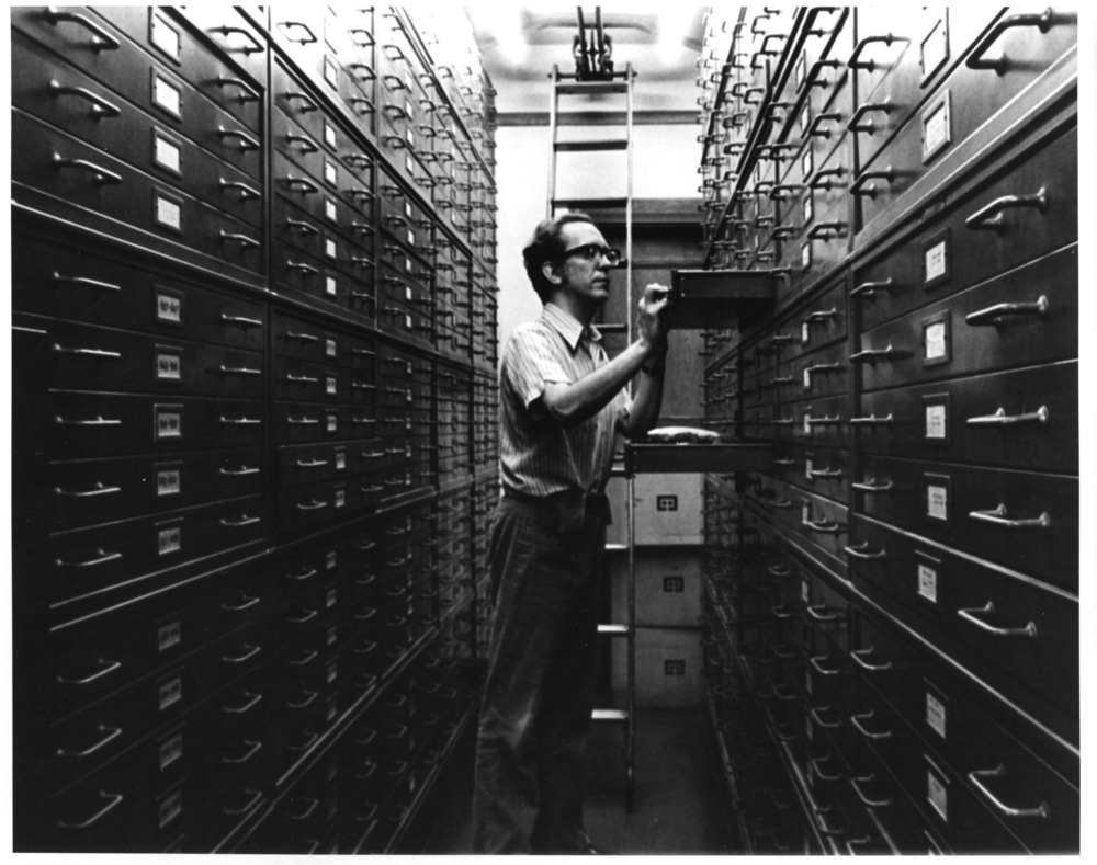Assyriologist Miguel Civil surrounded by cabinets containing clay fragments of cuneiform inscriptions. Courtesy of the Institute for the Study of Ancient Cultures.