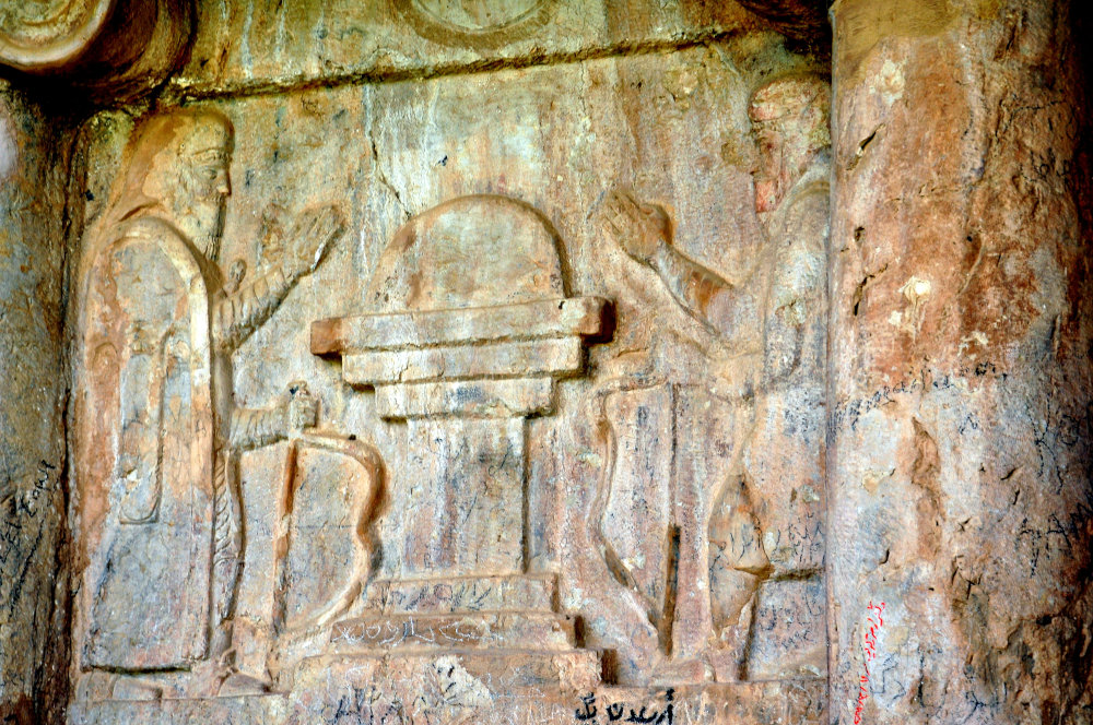 Detail of the main scene at façade of the rock-cut tombs at Qiz Qapan (Ashkawt-i Qizqapan; Kurdish which means the Cave of the Ravisher or the Cave of the Raped/Abducted Girl), Sulaymaniyah, Iraq. Two men, facing each other, wearing a Median attire, and holding bows before a stepped altar atop by sun or fire. Although the overall depiction is Median, the tombs are probably Achaemenid. 6th-4th century BCE. Note the vandalism and writings on the relief. Photo courtesy of the author.