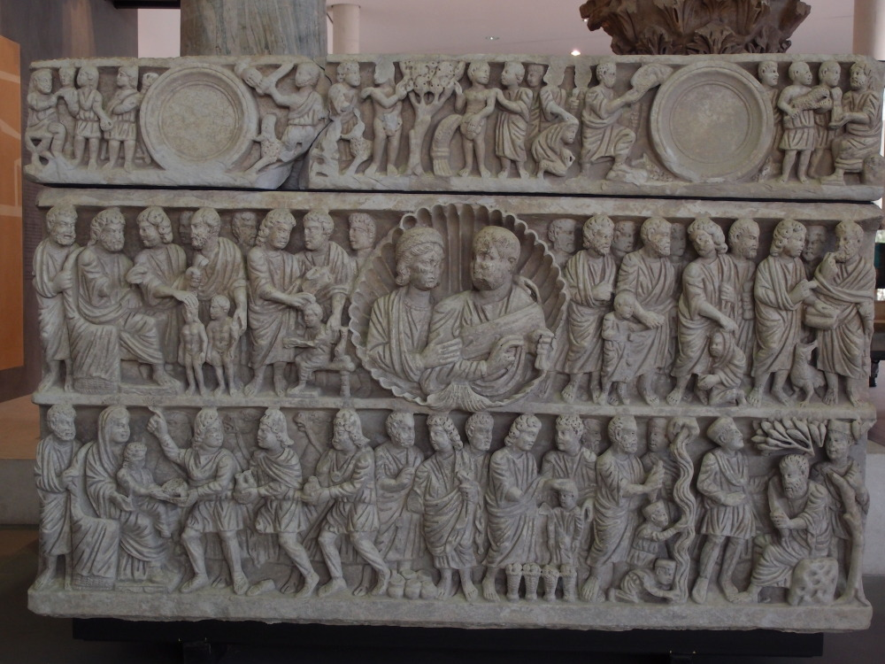 A famous fourth-century Christian sarcophagus from the Musée de l’Arles antique in France (“sarcophagus of the Trinity”). Peter is represented several times: second register on the right (his ‘denial’ with Christ and the cock), and in the third register below seated on a rock between two soldiers (maybe referring to his arrest). At the left of it he is performing a miracle (pouring water from a rock, later connected to the Mamertine prison near the Forum). Courtesy of the author.