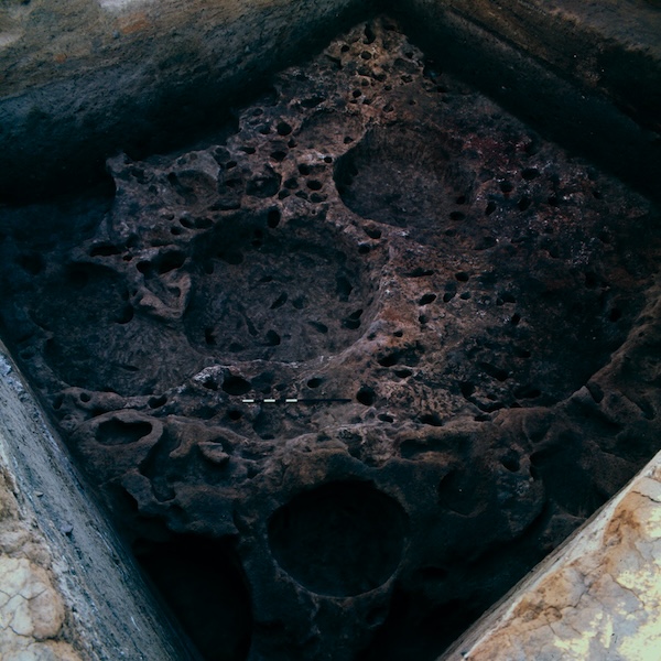 The pit houses of the hunter-gatherer village. Note the burned area on the right. Image courtesy of the author.