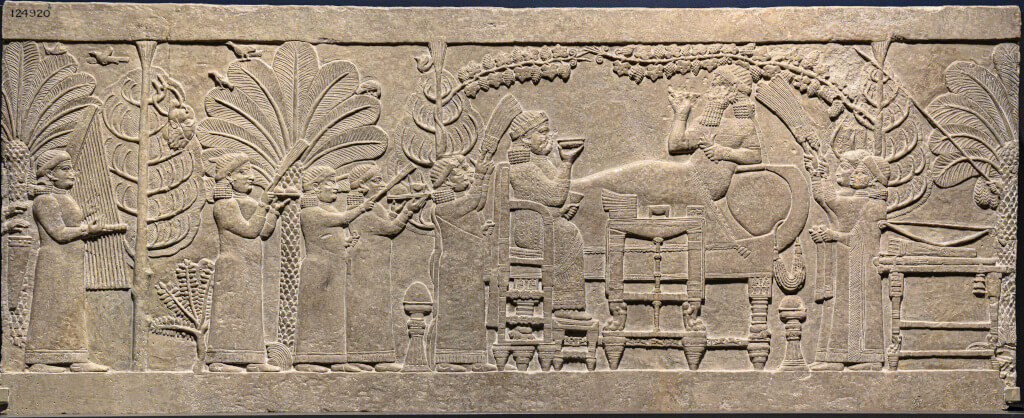 Nineveh, North Palace: gypsum wall panel relief showing the banquet of Ashurbanipal, c. 645-635 BCE; British Museum, inv. no. 124920 © The Trustees of the British Museum.