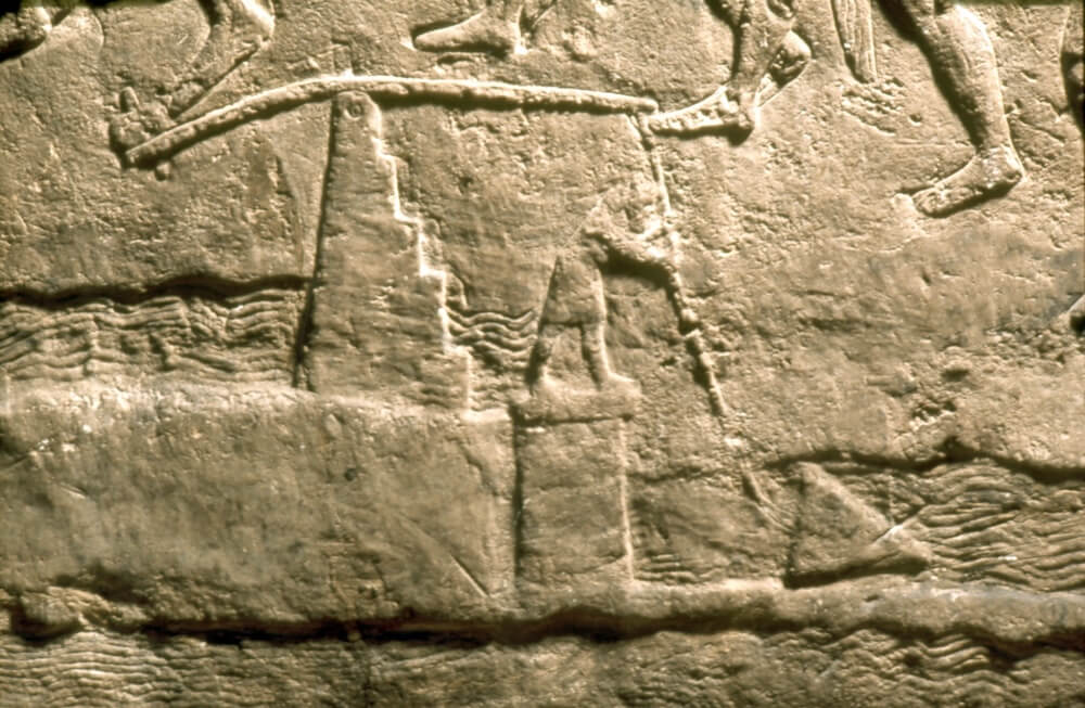 Assyrian relief sculpture from the seventh century BC showing the operation of a shadouf, a pivoted device for raising water from a canal. ©The Trustees of the British Museum.