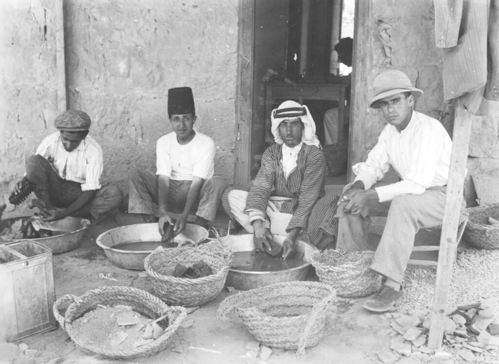 Figure 3. Day laborers washing pottery on the terrace of the dig house at Tell en-Naṣbeh, Badè Museum photographic archive A1094. Photographic negative. Courtesy of the Badè Museum, Pacific School of Religion.