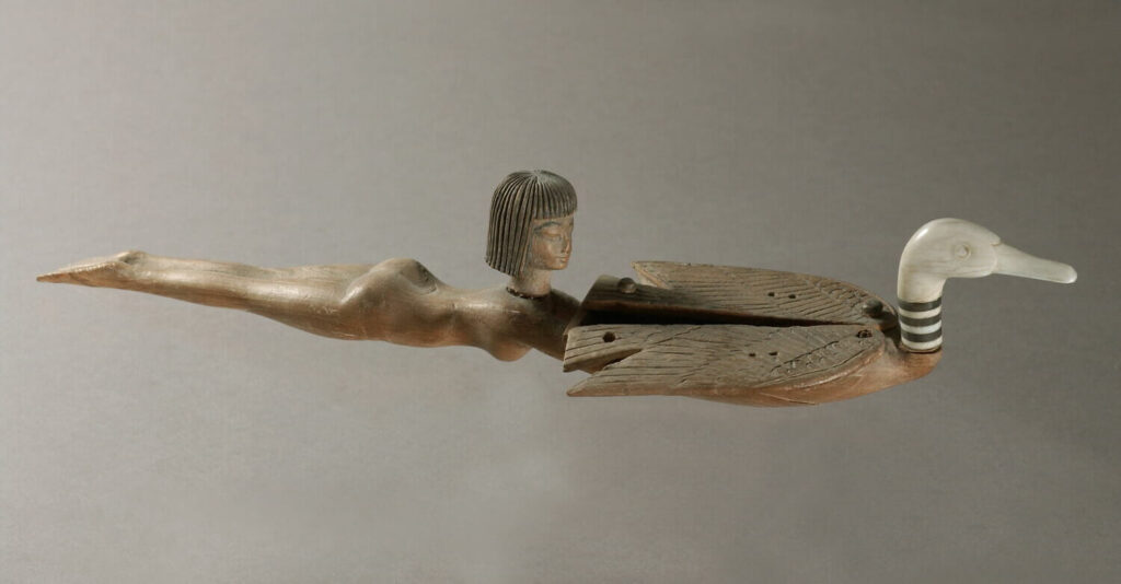 Fig. 1: Wood and ivory cosmetic spoon in the shape of a young girl swimming and holding a duck, New Kingdom, ca. 1400 BC–1300 BC. (© 2002 Musée du Louvre / Christian Déchamps.)