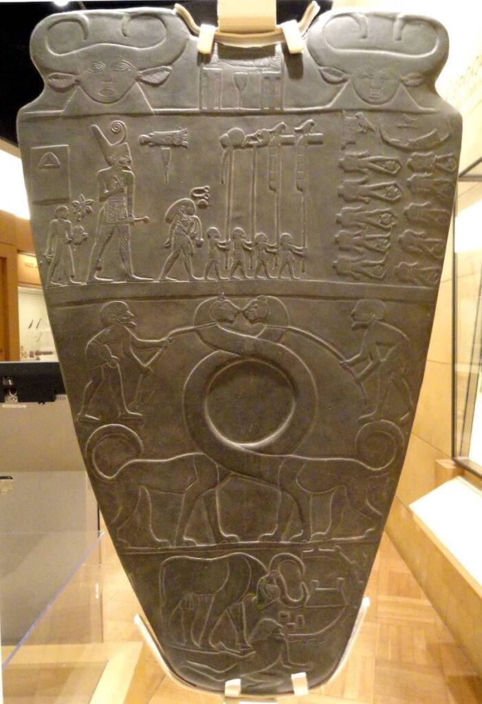 Fig. 1: Reproduction of the Palette of King Narmer, the first pharaoh of a unified Egypt. Original dated to ca. 3100 BCE. Royal Ontario Museum. Photo: Daderot, via Wikimedia Commons. CC0 1.0 Public Domain.