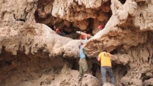 Archaeologists remove Roman swords from a cave near ‘En Gedi. Photo: Emil Aladjem, courtesy of the Israel Antiquities Authority.