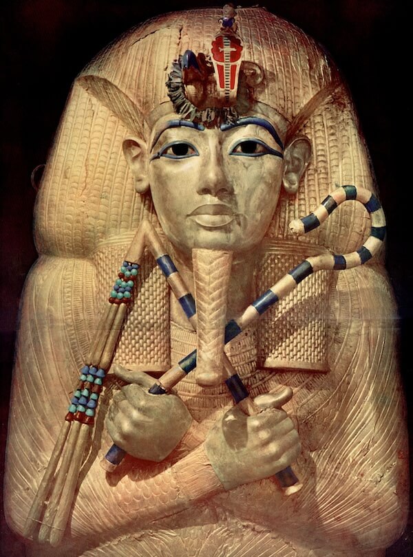 The outer coffin of Tutankhamun is of unusual form and the features of the face do not seem to match the other coffins and that has suggested to some scholars that it may have originally been constructed for someone else. Enhanced historic postcard image, author’s collection.