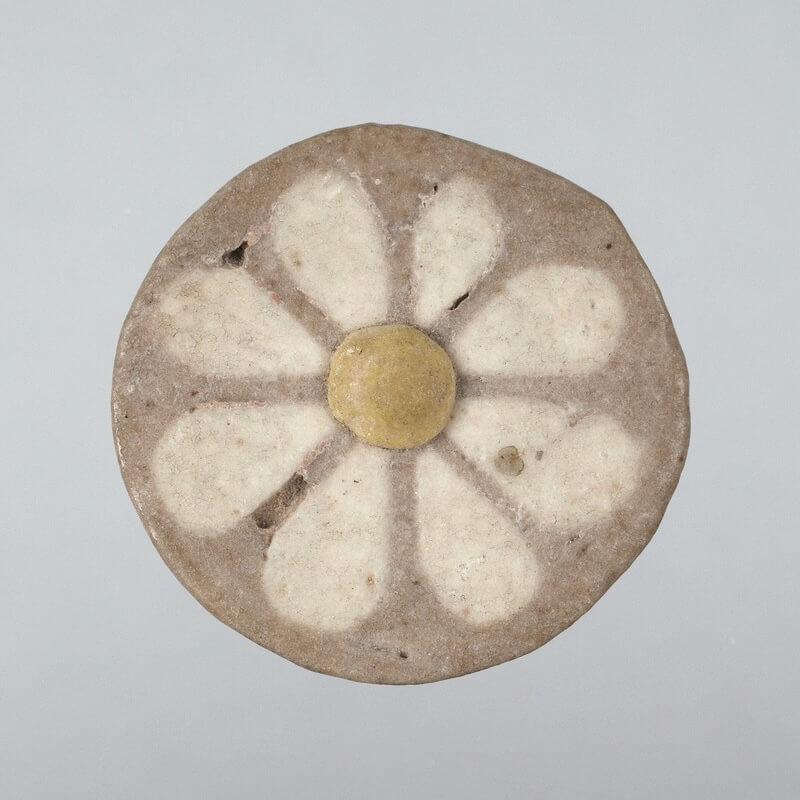 Figure 5. “Rosette plaque”, ca. 1175 BCE. We believe the rosette device so popular in the eastern Mediterranean in the late Bronze Age and Iron Age was inspired by the crown daisy. Photo courtesy of Princeton University Art Museum (object number y387b)