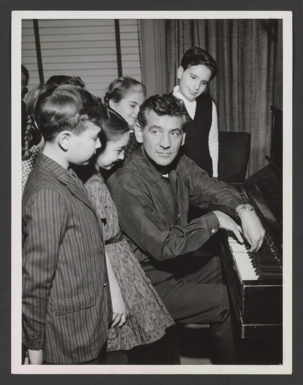 Leonard Bernstein backstage during a Young People's Concert. Note the young epople to the left and rear. (Library of Congress: Music Collection)