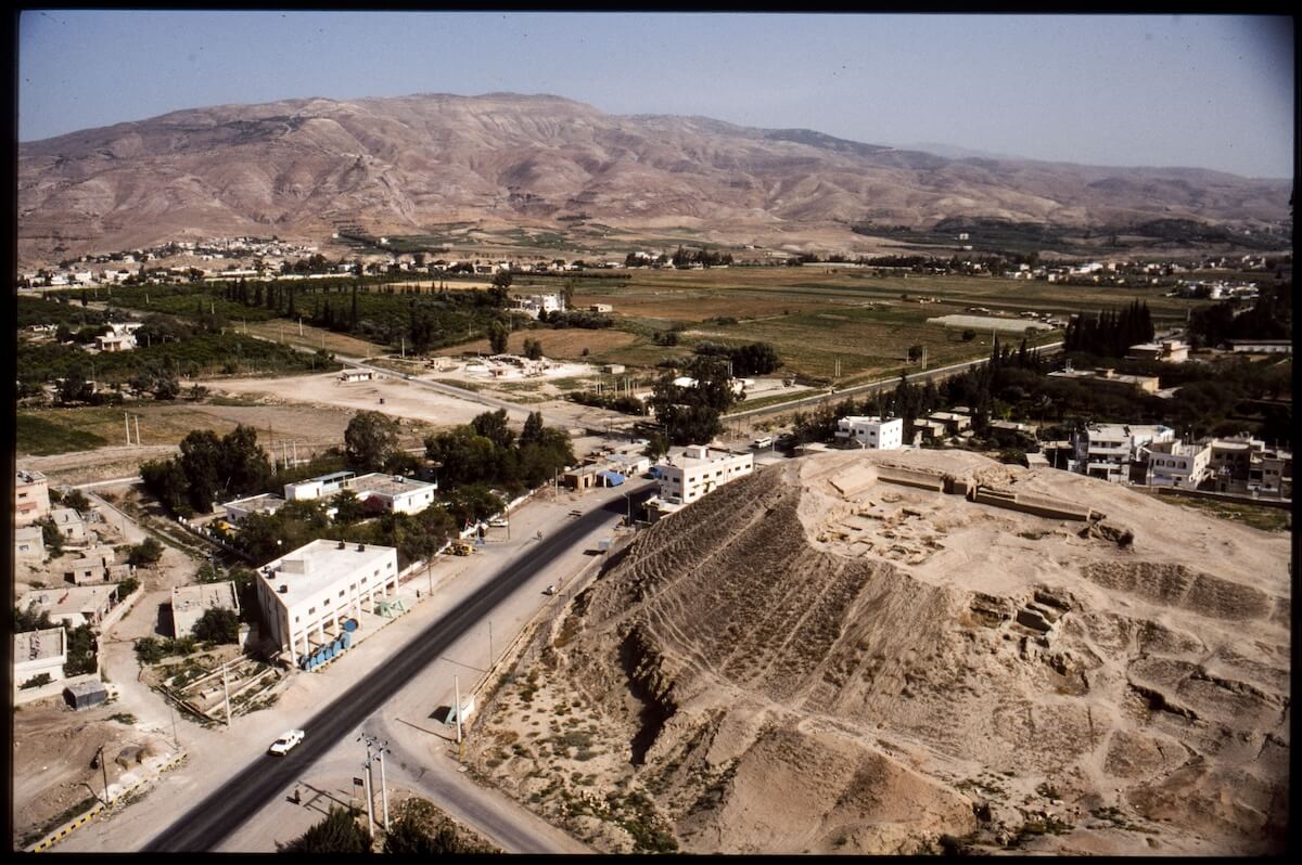 The site of Tell Deir ‘Alla in the Jordan Valley and the hills around Salt in the back as viewed from the Northwest. (APAAME_19990503_KDP-0195. Photograph by Konstantinos D. Politis, courtesy of APAAME).