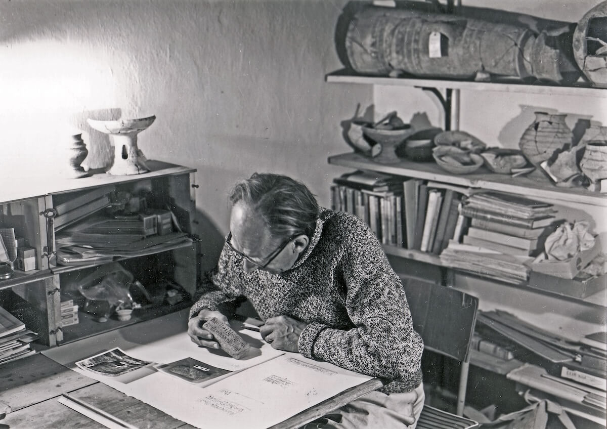 Henk Franken carefully examining tablet 1440, which was among the first tablets found within an auxiliary room of the temple complex. (Photo courtesy of the Deir ‘Alla excavation archive.)