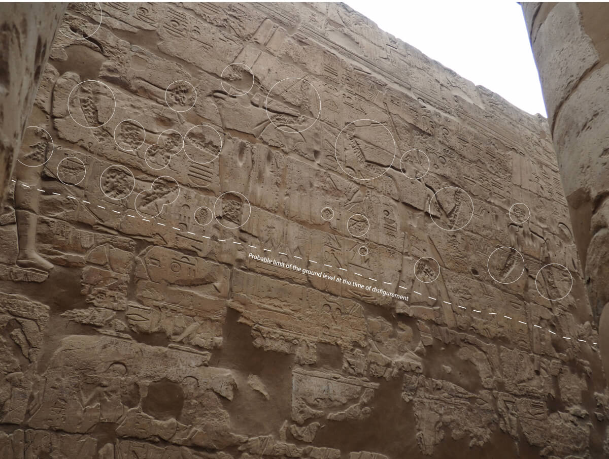 Relief on a wall of the Ramesside courtyard in the Luxor temple. The faces were completely erased with chisels, sometimes even high on the walls as well as on hieroglyphs. Arms, articulations, or the god’s phallus were repeatedly hammered. Quite considerable time and effort were dedicated to this defacement, since some parts of the images were not reachable without a ladder or scaffolding. These attacks always show themselves to be charged with a thorough intention, and a certain comprehension of the image to injure. They probably occurred at some point when the temple was reused for living, either during the Christian or the Islamic period. The destructive marks have to be differentiated from the cupules, vertical furrows visible for example on the chest of the god Amun, which are probably material manifestations of worship of wall images, which consisted of scraping the stone in order to get some powder. Such practices are attested through Pharaonic antiquity, until modern times. (Photo: S. Connor.)