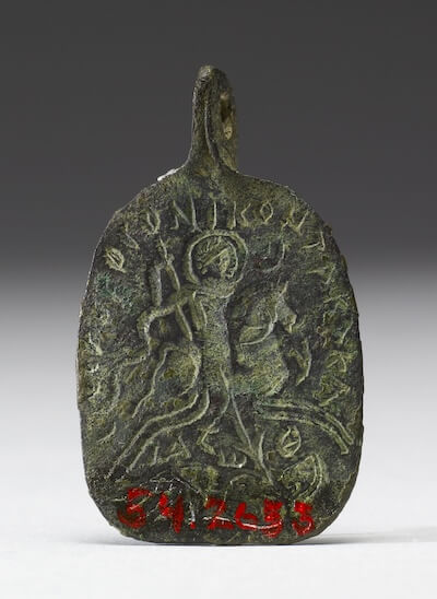 Amuletic pendant made of copper alloy. On top: the Holy Rider spears a fallen enemy (these figures are sometimes identified as Solomon and Lilith). On bottom: image of the “much suffering eye” attacked by a lion, snake, scorpion, stork, and various weapons. 5th or 6th century CE. Said to be from Israel. Walters Art Museum 54.2653. Photos: CC0 1.0 (Public Domain).