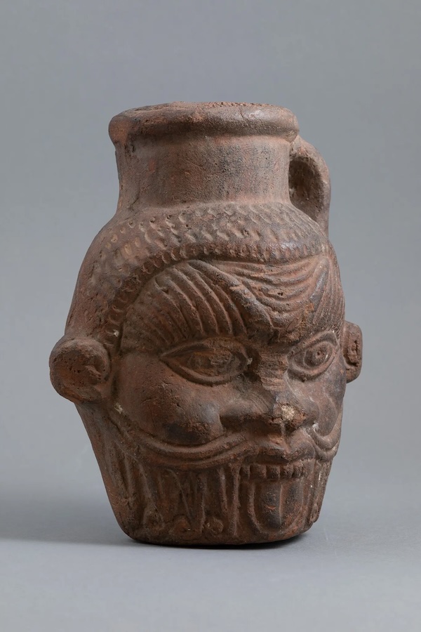 Drinking vessel in shape of Bes head, El-Fayūm Oasis, Egypt. Image Courtesy of the Tampa Museum of Art. 