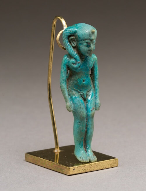 A nude Harpocrates standing in what appears to be a crouch gait pose commonly associated with cerebral palsy.