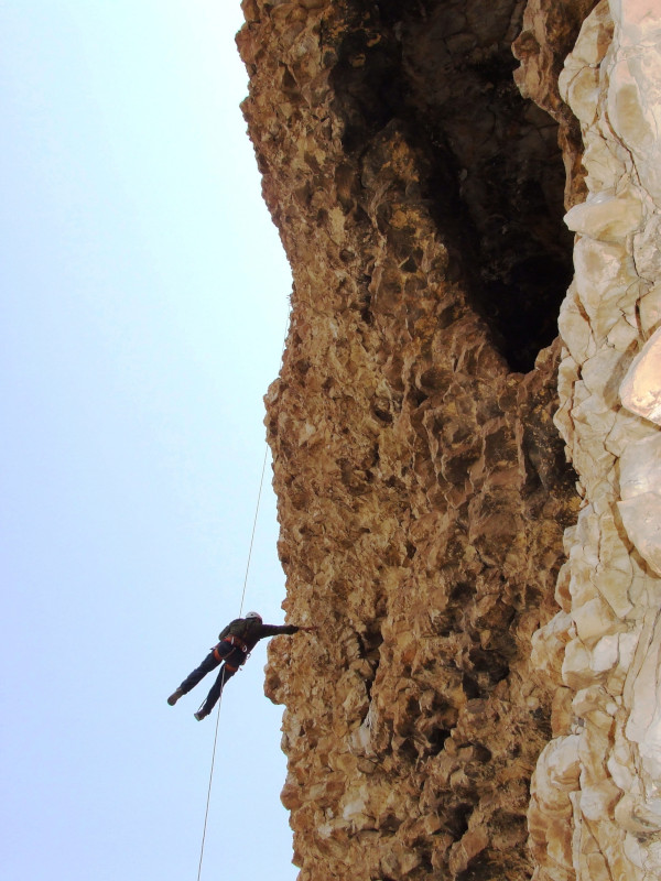 Rappelling into a cliff shelter at Akhbera Rock. Photo courtesy Yinon Shivtiel.