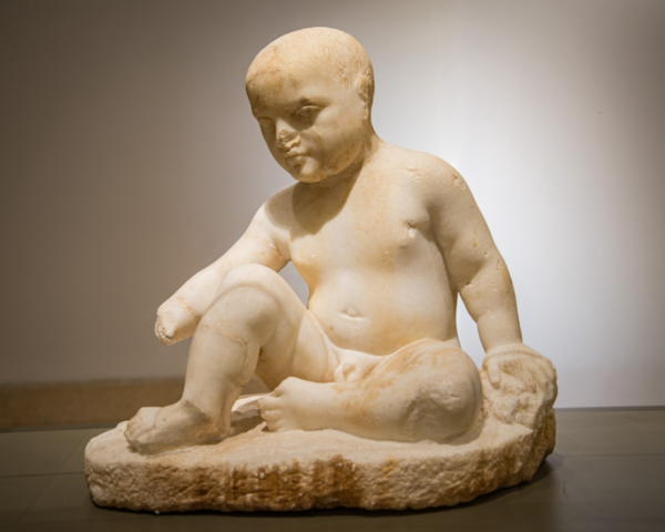 Votive statue of a seated boy from the sanctuary of Eshmun at Bostan ech-Sheikh (Sidon). Marble, ca. 450-300 BCE. Photo by J. Nitschke.