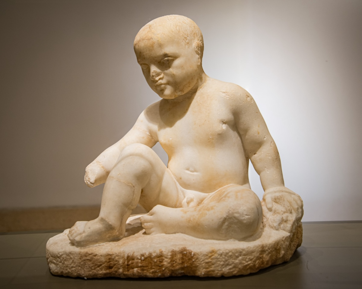Votive statue of a seated boy from the sanctuary of Eshmun at Bostan ech-Sheikh (Sidon). Marble, ca. 450-300 BCE. Photo by J. Nitschke.