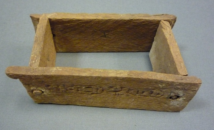 Model of a wooden mold for making mudbricks (length 10 cm/3.75 inches), recovered from the foundation deposit in front of the tomb of Hatshepsut (KV 20) in the Valley of the Kings, Egypt (ca. 1479-1458 BCE). Metropolitan Museum of Art 20.8.7. Public Domain. 