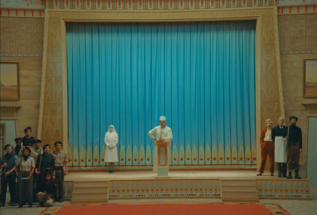 Ballroom in the “Royal Majestic Imperial Calouste Korda Desert Oasis Palace.” Still image from The Phoenician Scheme (2025), directed by Wes Anderson. Courtesy of Focus Features.