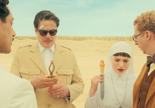 Korda (Benicio del Toro) and Liesel (Mia Threapleton) hold daggers fashioned in what can be termed an Egyptianizing style; that held by Liesel has pseudo-hieroglyphs on the blade. Still image from The Phoenician Scheme (2025), directed by Wes Anderson. Courtesy of Focus Features.
